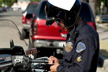 police writing out traffic ticket